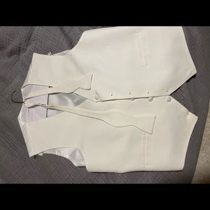 White pique tuxedo vest and matching self tie bow tie. Size large